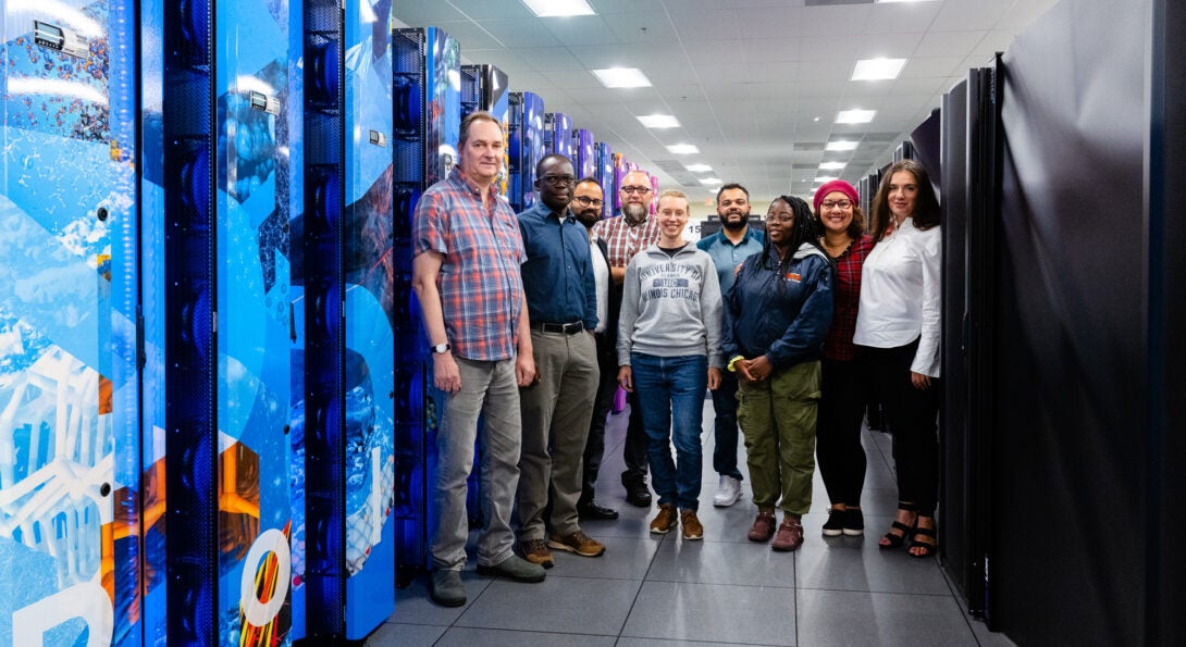 ACER staff members with the Polaris supercomputer at Argonne